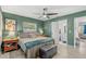 Relaxing bedroom with a king-size bed, green walls, and access to a bathroom at 631 Callahan St, Winter Park, FL 32789