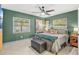 Serene bedroom with a king-size bed, ceiling fan, and green walls at 631 Callahan St, Winter Park, FL 32789