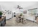 Open concept dining area with modern light fixtures and a view into the kitchen at 631 Callahan St, Winter Park, FL 32789