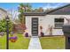 Modern house exterior featuring a white facade, black accents, and a landscaped front yard at 631 Callahan St, Winter Park, FL 32789