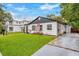 Charming house exterior with a lush green lawn and beautiful landscaping at 631 Callahan St, Winter Park, FL 32789