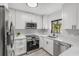 Modern white kitchen with stainless steel appliances and white shaker cabinets at 631 Callahan St, Winter Park, FL 32789