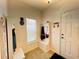 White entryway with storage bench, coat hooks, and a view into the living area at 6976 Church Lake St, Groveland, FL 34736