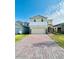 Two-story house with a two-car garage and a brick paved driveway at 6976 Church Lake St, Groveland, FL 34736