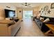 Living room with sliding glass doors, neutral color palette, and ceiling fan at 6976 Church Lake St, Groveland, FL 34736