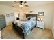 Main bedroom with gray platform bed, nightstands, and dresser at 6976 Church Lake St, Groveland, FL 34736