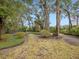 Landscaped backyard with mature trees at 7718 Flemingwood Ct, Sanford, FL 32771