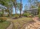 Stone path leads to a screened pool area at 7718 Flemingwood Ct, Sanford, FL 32771