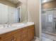 Double vanity bathroom with large shower and light wood cabinets at 7718 Flemingwood Ct, Sanford, FL 32771