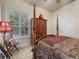 Bedroom with four-poster bed, window seat, and hardwood floors at 7718 Flemingwood Ct, Sanford, FL 32771