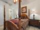 Bedroom with four-poster bed, ceiling fan, and access to upper level at 7718 Flemingwood Ct, Sanford, FL 32771