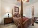 Bedroom with four-poster bed, ceiling fan, and hardwood floors at 7718 Flemingwood Ct, Sanford, FL 32771