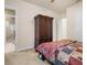 Bedroom with ensuite bathroom access and large armoire at 7718 Flemingwood Ct, Sanford, FL 32771