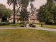 Two-story house with tile roof and landscaped yard at dusk at 7718 Flemingwood Ct, Sanford, FL 32771