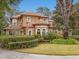 Two-story house with tile roof and lush landscaping at 7718 Flemingwood Ct, Sanford, FL 32771