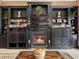 Elegant fireplace is the focal point of this living room, surrounded by built-in shelving at 7718 Flemingwood Ct, Sanford, FL 32771