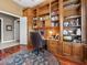 Home office features built-in wooden shelving and desk at 7718 Flemingwood Ct, Sanford, FL 32771