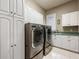 Laundry room with washer, dryer, and cabinets at 7718 Flemingwood Ct, Sanford, FL 32771