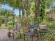 Small patio with table and chairs, lush foliage at 7718 Flemingwood Ct, Sanford, FL 32771