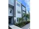 Modern building exterior with gray and blue accents, landscaping, and walkway at 7770 Sandy Ridge Dr # 126, Reunion, FL 34747