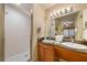 Bathroom with shower, double vanity, and granite countertop at 8101 Resort Village Dr # 31308, Orlando, FL 32821
