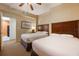 Guest bedroom with two twin beds, nightstand, and ceiling fan at 8101 Resort Village Dr # 31308, Orlando, FL 32821