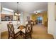 Bright dining area with a glass-top table and four chairs, adjacent to kitchen at 8101 Resort Village Dr # 31308, Orlando, FL 32821