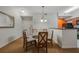 Dining area with glass-top table and four chairs at 8101 Resort Village Dr # 31308, Orlando, FL 32821