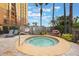 Community hot tub with lounge chairs and landscaping at 8101 Resort Village Dr # 31308, Orlando, FL 32821