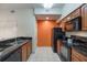 Modern kitchen with black appliances and granite countertops at 8101 Resort Village Dr # 31308, Orlando, FL 32821