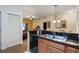 Well-equipped kitchen with dark countertops and wood cabinets at 8101 Resort Village Dr # 31308, Orlando, FL 32821