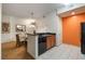 Kitchen with breakfast bar and view into dining area at 8101 Resort Village Dr # 31308, Orlando, FL 32821