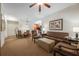 Living room with sofa, armchairs, and ceiling fan at 8101 Resort Village Dr # 31308, Orlando, FL 32821