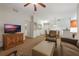 Living room with flat-screen TV and view of dining area at 8101 Resort Village Dr # 31308, Orlando, FL 32821