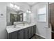 Bathroom with gray vanity, double sinks and large mirror at 8134 Sw 78Th Terrace Rd, Ocala, FL 34476