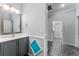 Modern bathroom with gray vanity and a large mirror at 8134 Sw 78Th Terrace Rd, Ocala, FL 34476