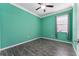 Bright bedroom with teal walls and dark wood floors at 8134 Sw 78Th Terrace Rd, Ocala, FL 34476