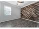 Bedroom with wood-look floors and accent wall at 8134 Sw 78Th Terrace Rd, Ocala, FL 34476