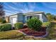 Landscaped front yard of a light blue one-story house at 8134 Sw 78Th Terrace Rd, Ocala, FL 34476