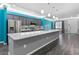 Modern kitchen with gray cabinets, white countertops and a teal accent wall at 8134 Sw 78Th Terrace Rd, Ocala, FL 34476