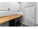 Bright laundry room featuring white cabinets and butcher block countertop at 8134 Sw 78Th Terrace Rd, Ocala, FL 34476