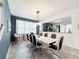 Dining room with marble table, eight chairs, and modern chandelier at 8953 Hilton Ridge Ave, Kissimmee, FL 34747