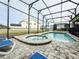 Relaxing pool and spa area with blue lounge chairs and a screened enclosure at 8953 Hilton Ridge Ave, Kissimmee, FL 34747