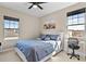 Spacious bedroom with a queen-size bed, a desk, and large windows at 9203 Neher St, Orlando, FL 32827