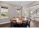 Dining room with round table, chairs, and hardwood floors at 9203 Neher St, Orlando, FL 32827