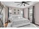 Main bedroom with barn doors, ceiling fan, and ample natural light at 9203 Neher St, Orlando, FL 32827