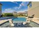 Inviting pool with swim-up lounge chairs and a fire feature at 9203 Neher St, Orlando, FL 32827