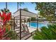 Relaxing pool area with shaded seating and lounge chairs at 9203 Neher St, Orlando, FL 32827