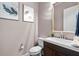 Modern powder room with wood vanity and a large mirror at 9203 Neher St, Orlando, FL 32827