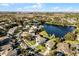 Aerial view of a house near a lake, surrounded by other homes at 9657 Pacific Pines Ct, Orlando, FL 32832